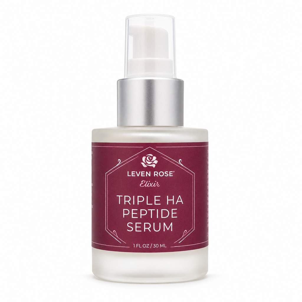 A bottle of Leven Rose Elixir Triple Ha Peptide Serum with a frosted glass body, a metallic silver pump collar, and a deep burgundy label with white text.