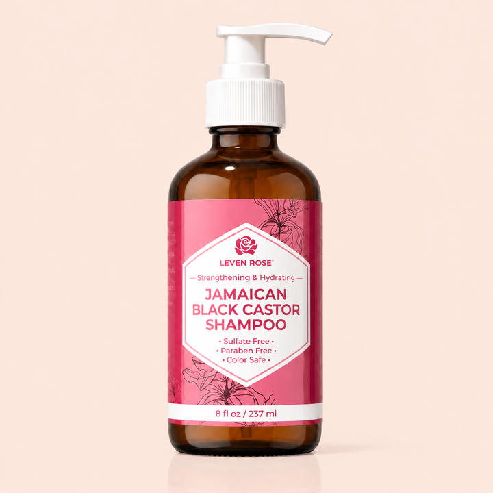 Brown bottle of Jamaican Black Castor Shampoo with a pink label on a beige background