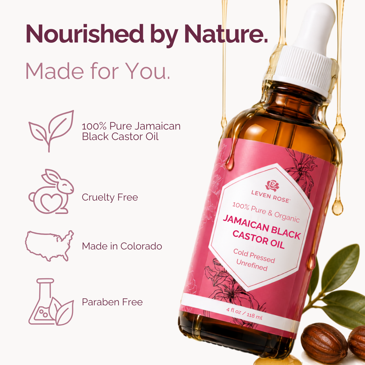 A bottle of Leven Rose Jamaican Black Castor Oil shown at an angle with decorative text and icons on a light background. The bottle is amber glass with a white dropper cap and a pink label.