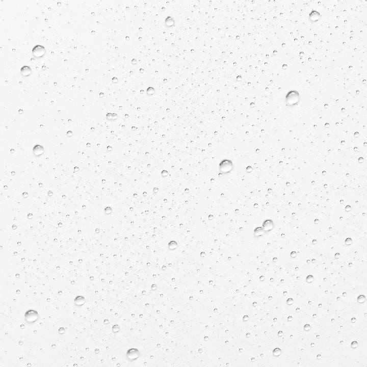 A close-up texture of clear water droplets scattered across a smooth, light gray surface.