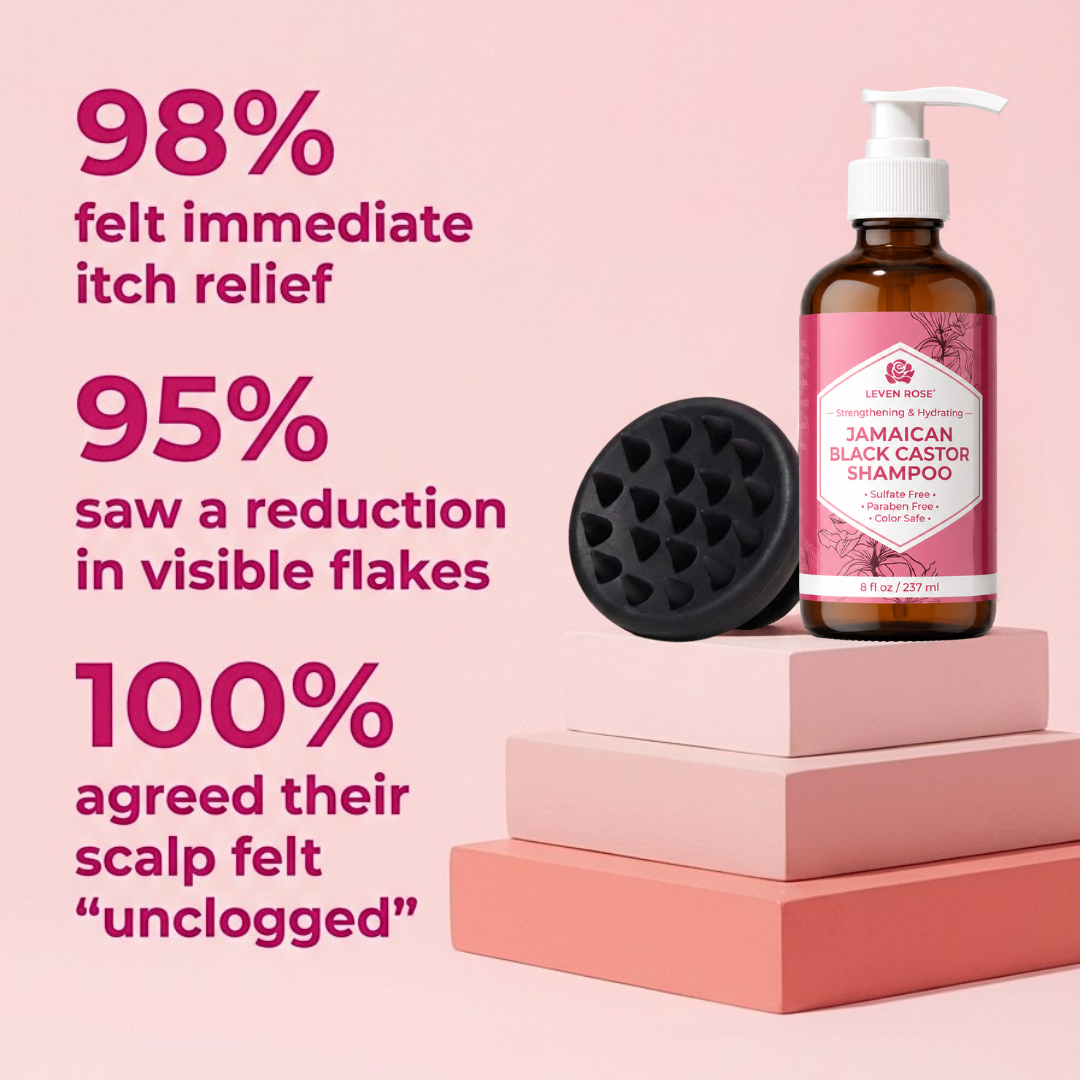 A bottle of Luv Rose Jamaican Black Castor Shampoo stands on pink display blocks next to a black silicone scalp massager, with large marketing text on a soft pink background.
