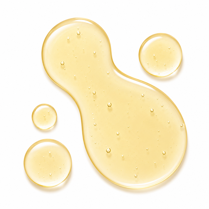 A translucent golden-yellow liquid droplet with small bubbles, shown on a clean white background alongside three smaller matching droplets.