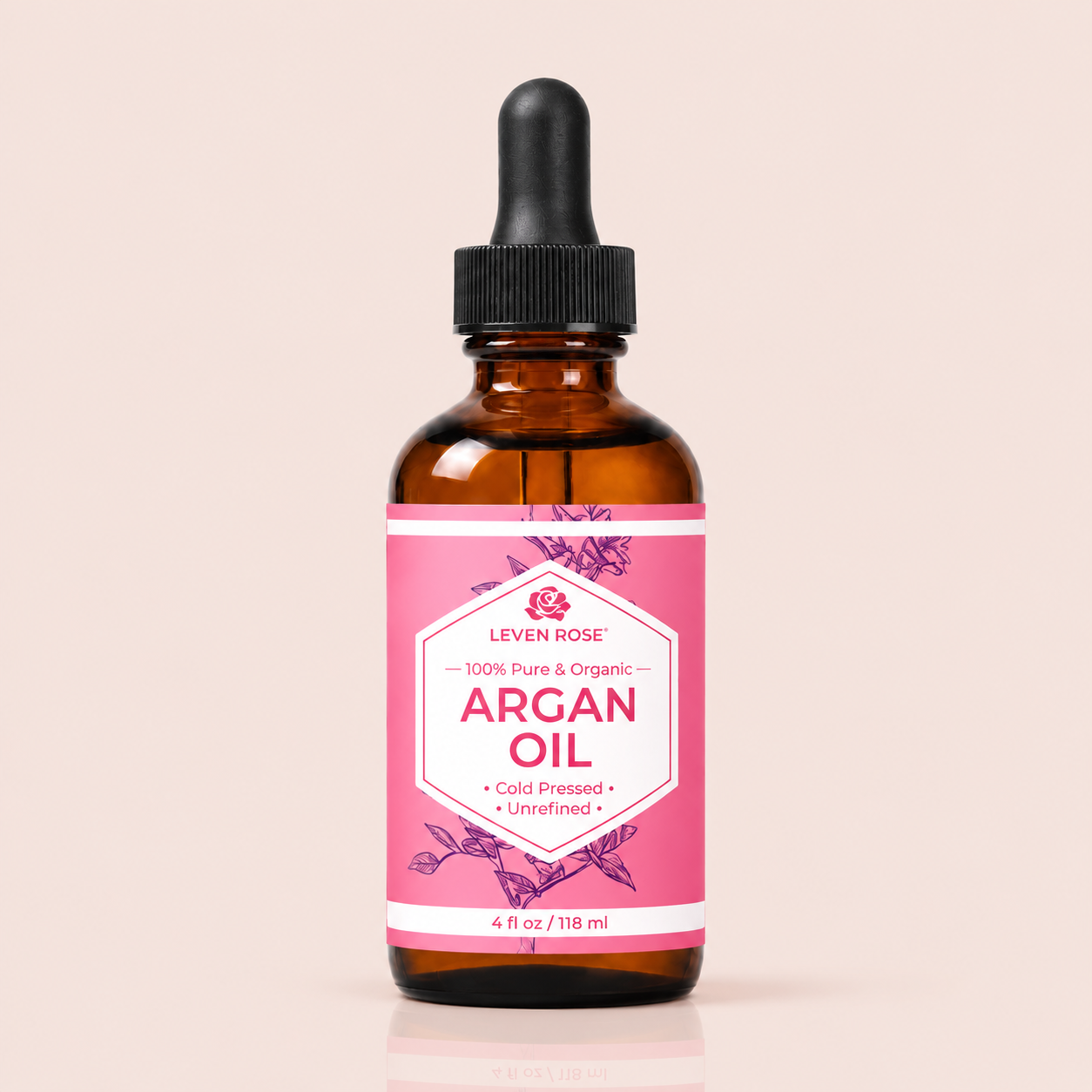 Bottle of Leven Rose Argan Oil with a pink label on a beige background