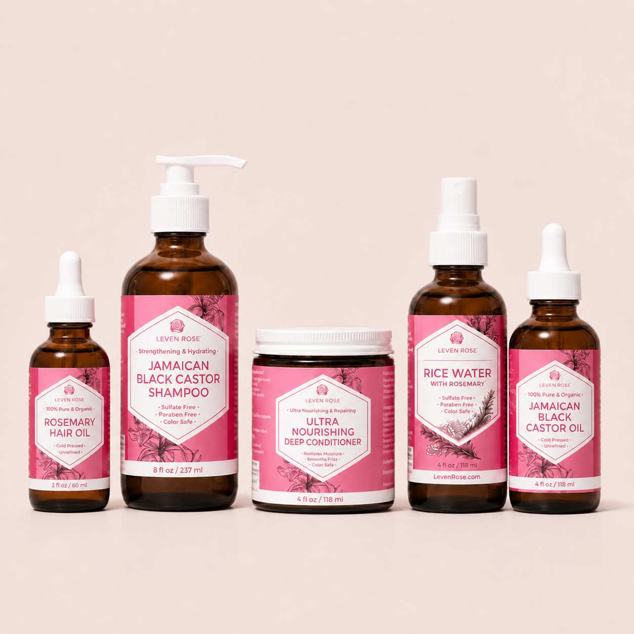 Six Levity Rose haircare products arranged on a light beige background: two small dropper bottles, one pump bottle, one jar, and one spray bottle. The labels are predominantly pink with white text, and the bottles are amber brown.