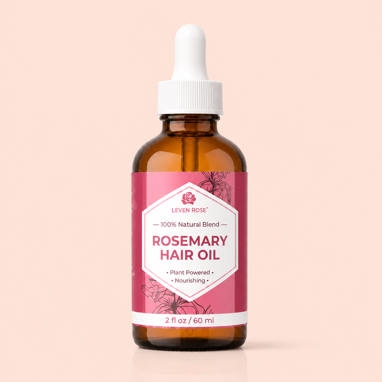 Brown bottle of Leven Rose Rosemary Hair Oil with a pink label on a beige background