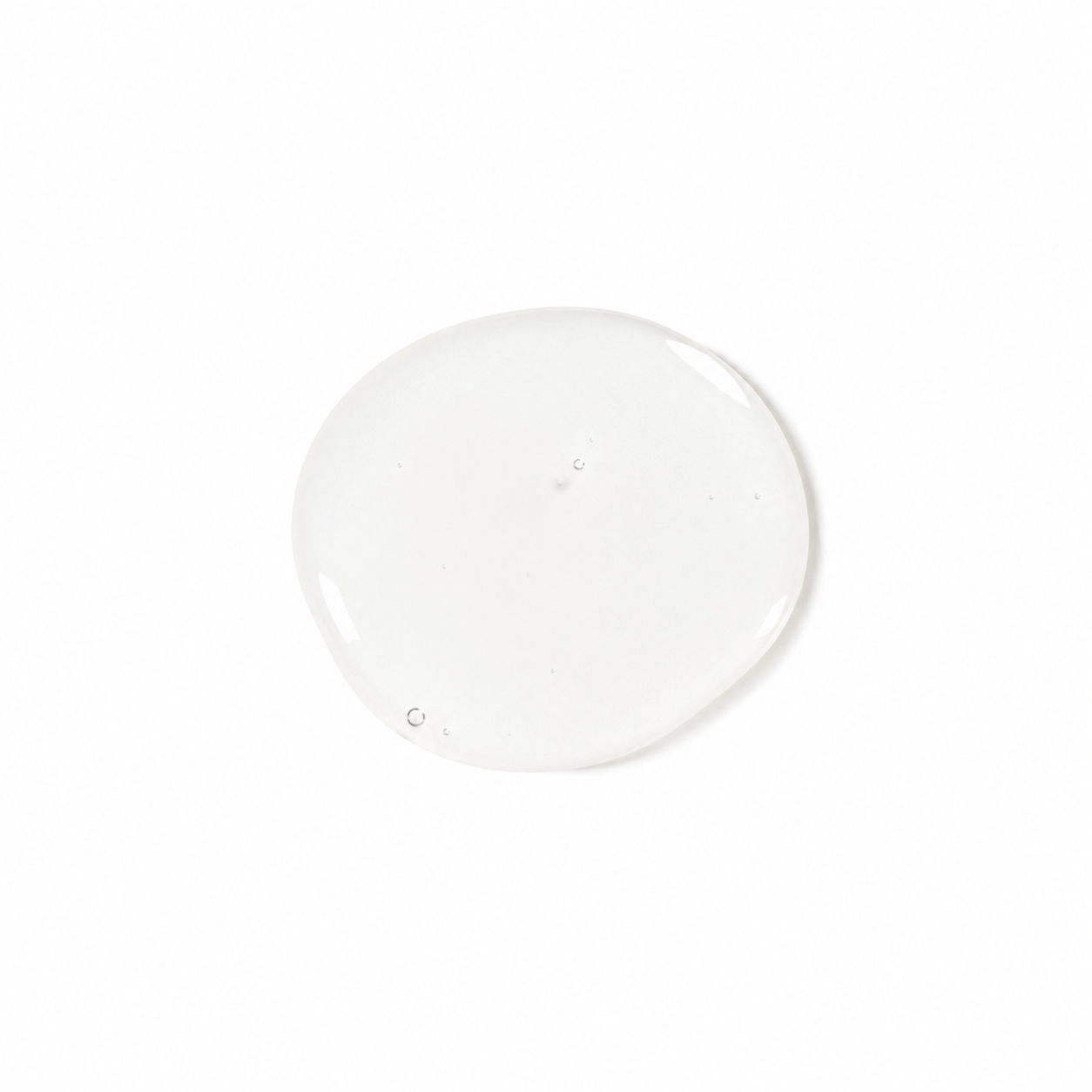 A single glossy, translucent clear gel or liquid droplet centered on a solid white background.
