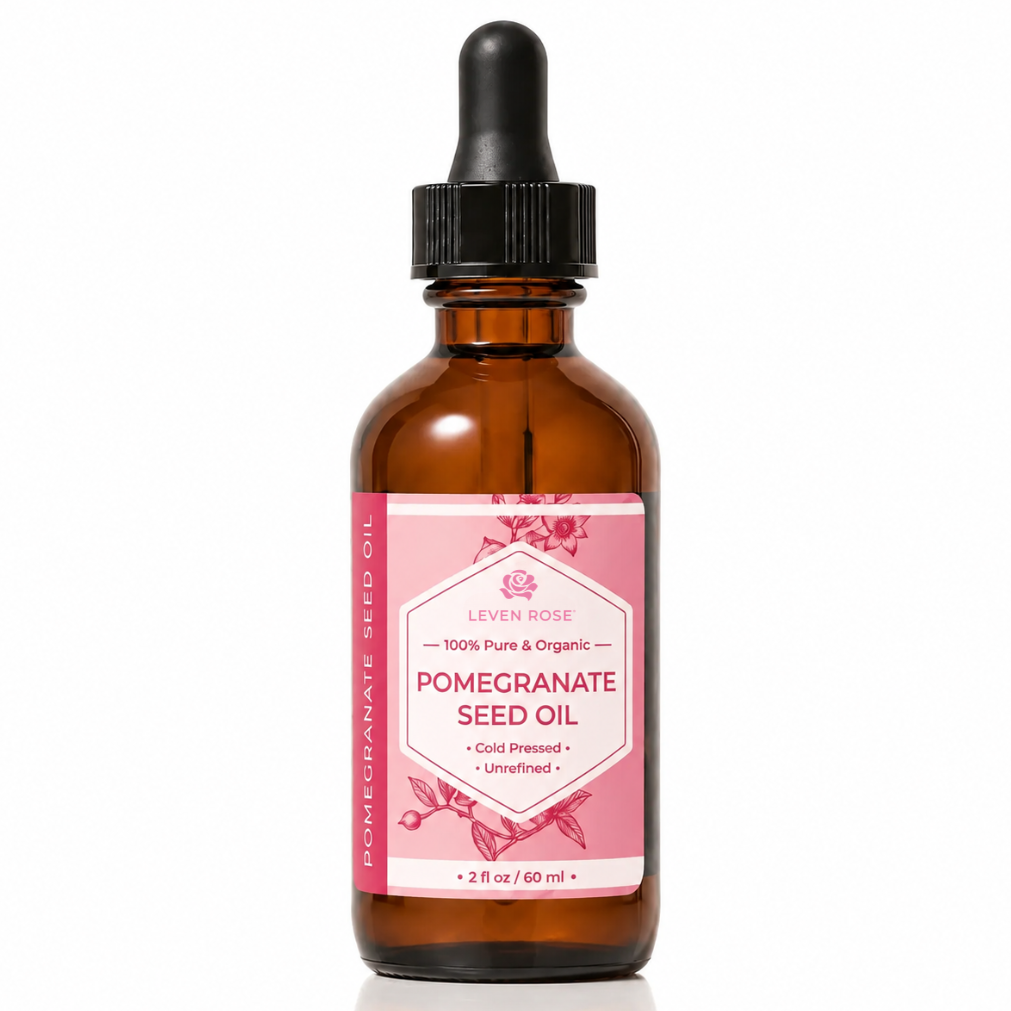 A 2 fl oz amber glass dropper bottle of Levain Rose Pomegranate Seed Oil with a pink label and black dropper cap, set against a clean white background.