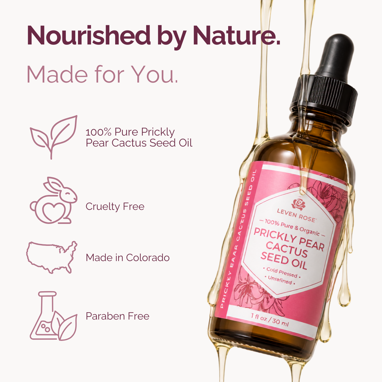 A bottle of Leven Rose Prickly Pear Cactus Seed Oil with a pink label and black dropper cap, shown on a light background with decorative text and icons about pure prickly pear, cruelty free, made in Colorado, and paraben free. Gold oil is dripping around the bottle.