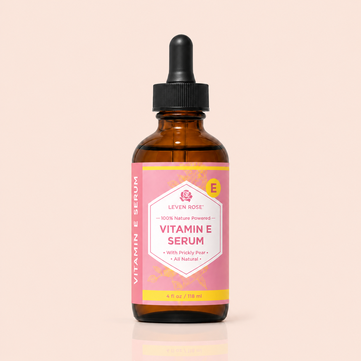Vitamin E serum bottle with pink label on a beige background