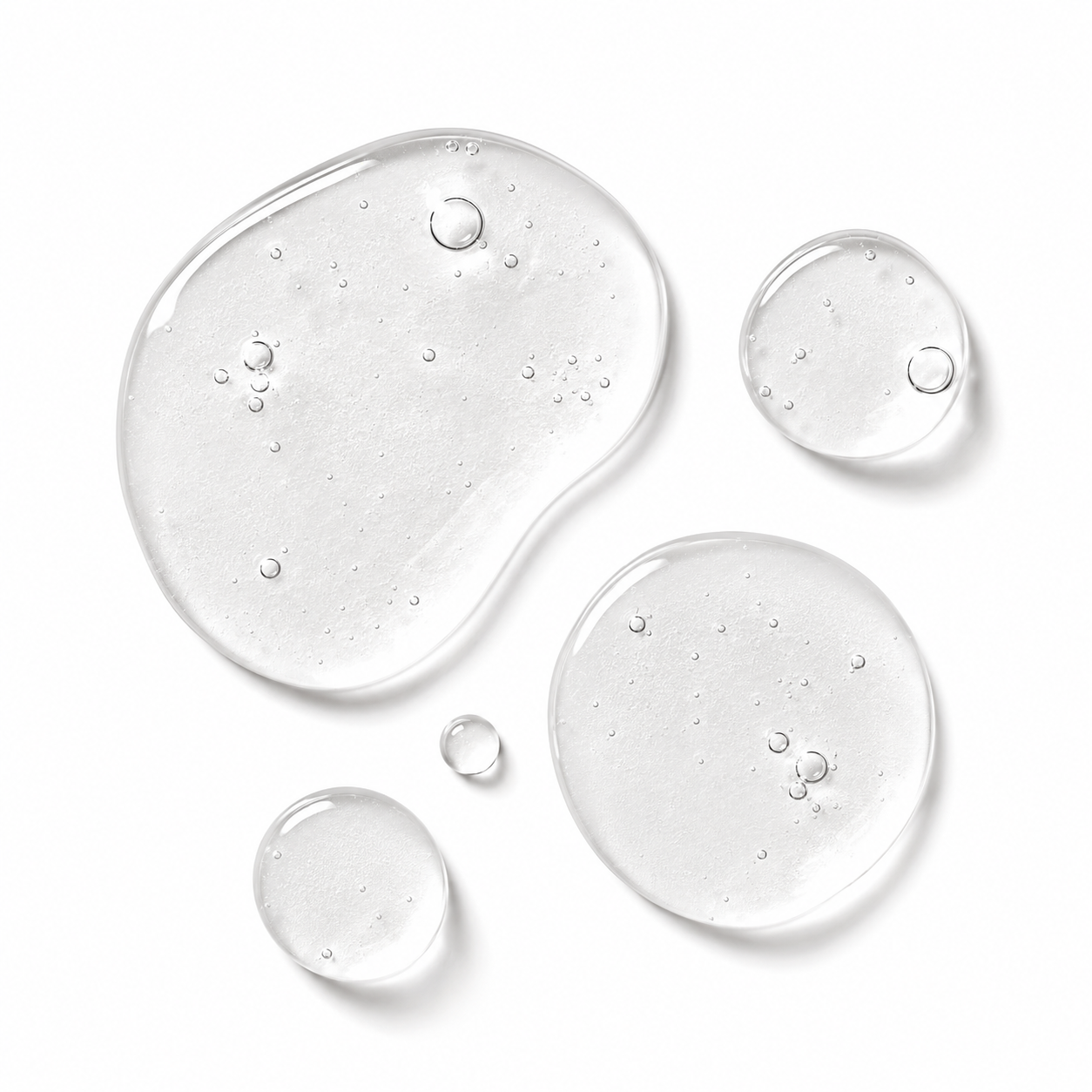 Five clear liquid droplets of varying sizes with visible air bubbles, arranged on a clean white background.