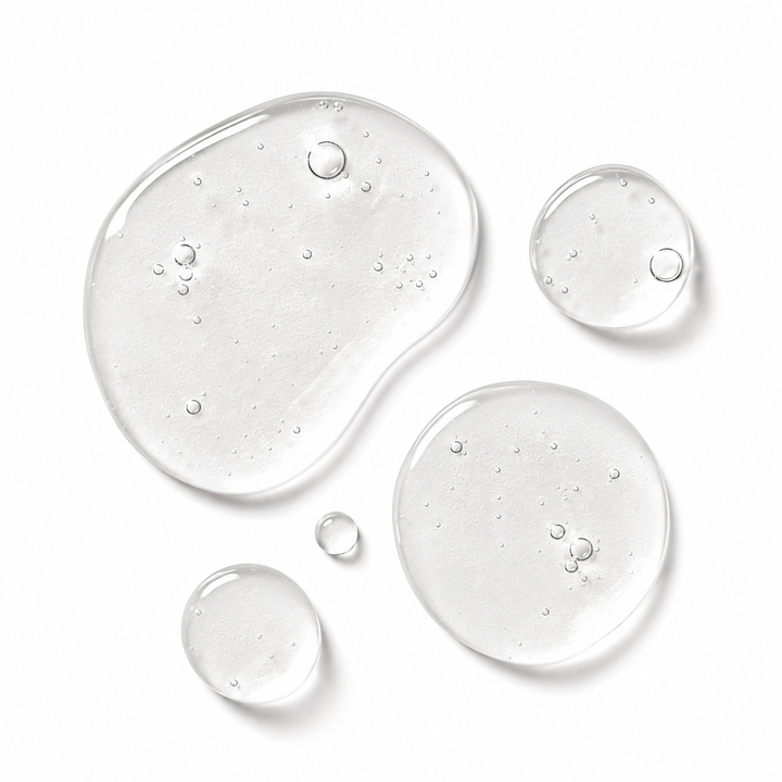 Five clear liquid droplets of varying sizes with visible air bubbles, arranged on a clean white background.